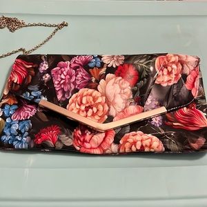 Katie & Kelly black and floral multicolor design. Gold chained shoulder strap.